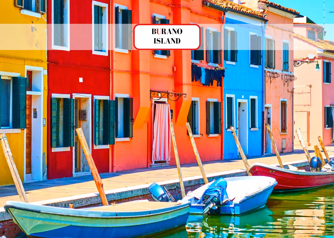 Vibrant houses along Burano canal with colorful boats, showcasing the island's iconic charm and picturesque appeal.