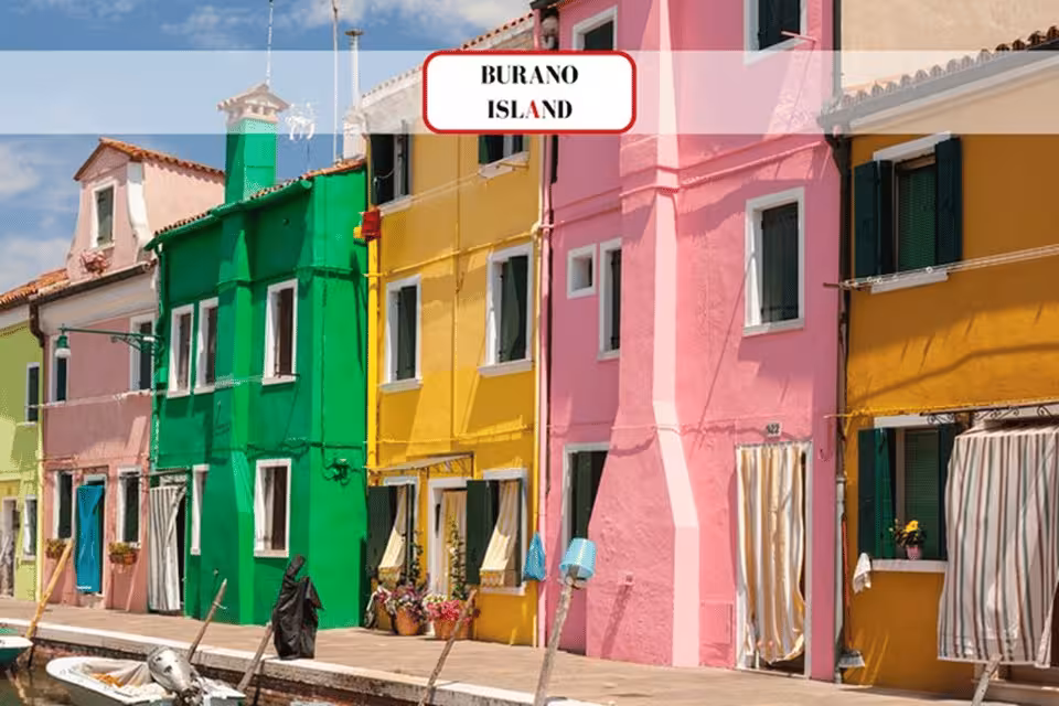 Vibrant pink, yellow, and green houses line the canal on Burano Island, highlighting the charm of Venetian architecture.