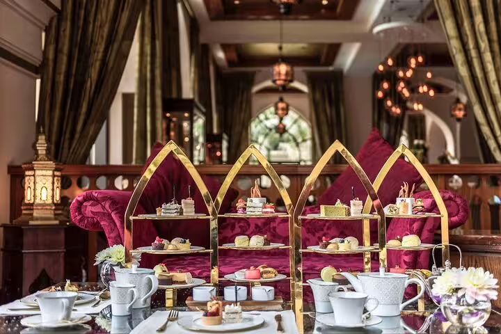 Elegant afternoon tea at Al Bayt lounge with Arabic-style tiered stands, pastries and Burj Khalifa tour ambiance in Dubai