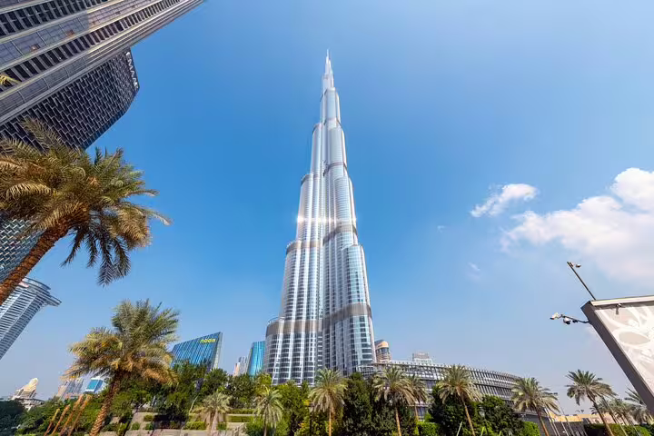 Burj Khalifa rising over Downtown Dubai on a private layover tour, iconic city highlight with palm gardens