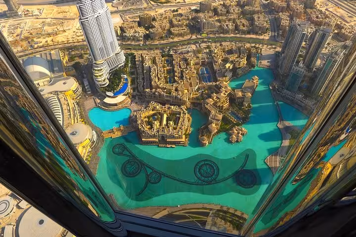 Bird’s-eye view of Dubai Fountain and Downtown from Burj Khalifa, included in The Roof Top Meal ticket tour