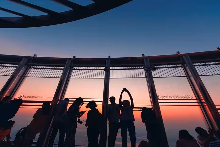 Visitors at Burj Khalifa rooftop observation deck at sunset, Dubai skyline views with ticket and meal