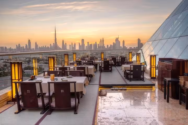 Sunset rooftop dining terrace overlooking Burj Khalifa, included in Dubai Burj Khalifa ticket with rooftop meal