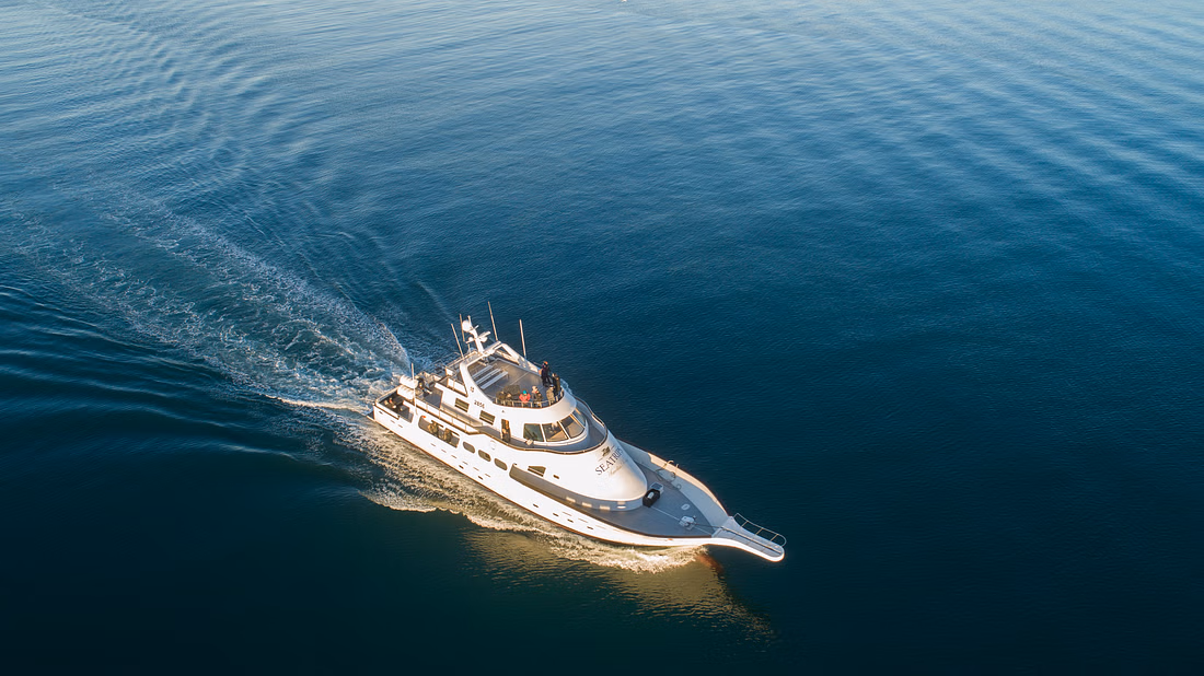 An aerial shot of a yacht at sea
