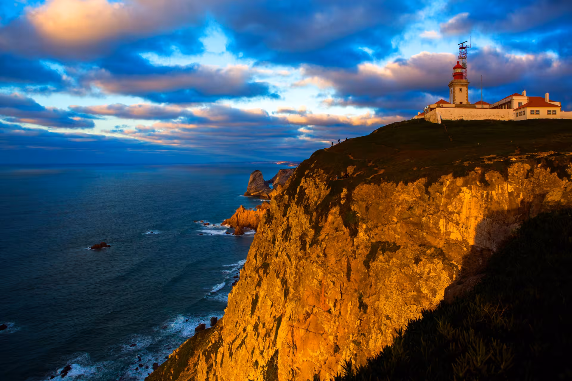 Cabo da Roca lighthouse at sunset, dramatic Atlantic cliffs on a Sintra and Cascais coastal tour