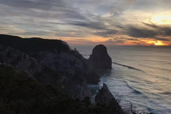 Stunning sunset over the dramatic cliffs of Cabo da Roca, offering breathtaking views on a Sintra-Cascais jeep tour.