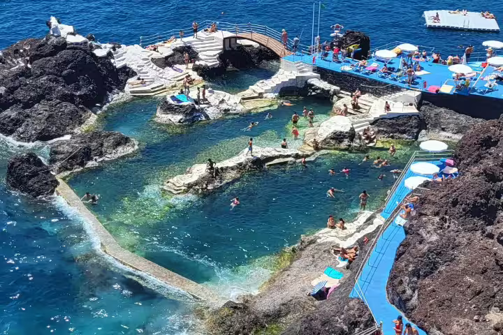 Stunning coastal swimming area with natural rock pools and sunbathing terraces featured in Cabo Girão full-day tour.