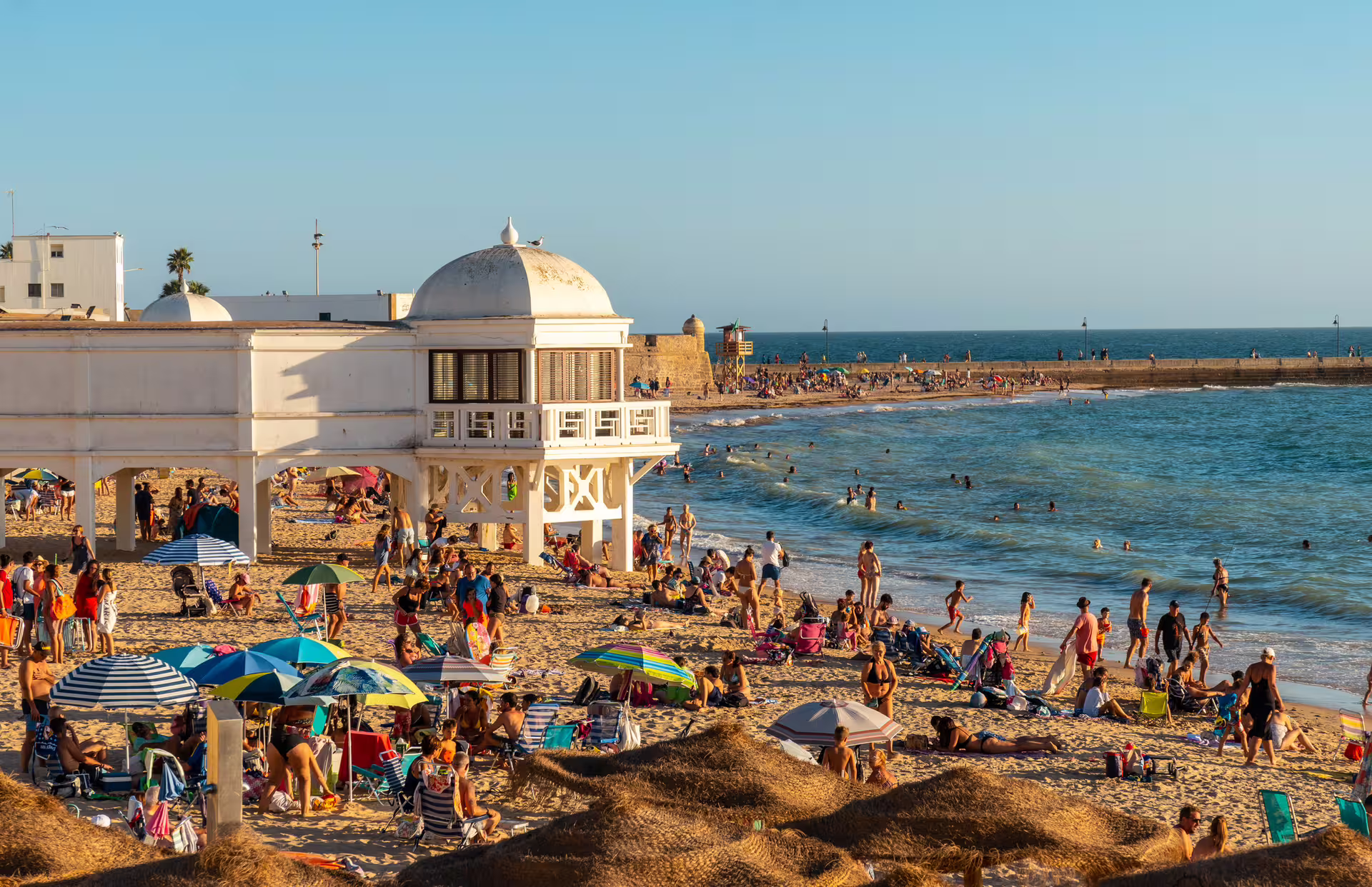La Caleta Beach and Balneario de la Palma at golden hour, highlight of Cadiz 1-day walking tour with audioguide
