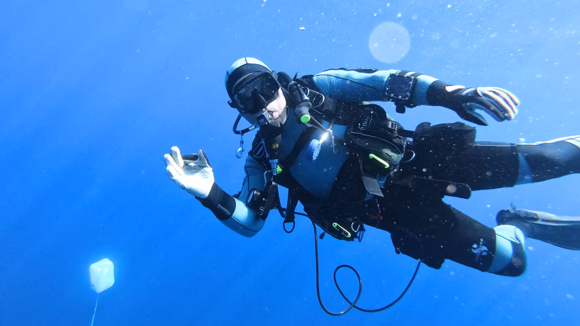 Diver exploring vibrant underwater world in Cagliari's crystal-clear waters on a beginner scuba diving adventure.