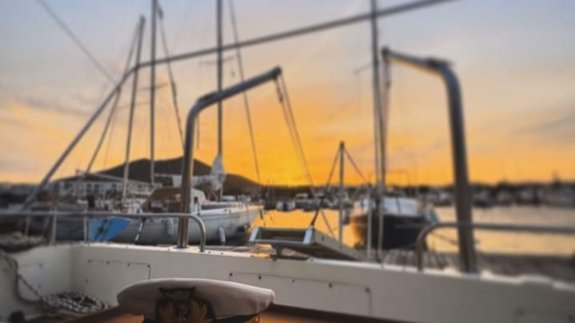 Serene sunset at a marina in Cagliari, with yachts silhouetted against the golden sky, perfect for a boat tour.