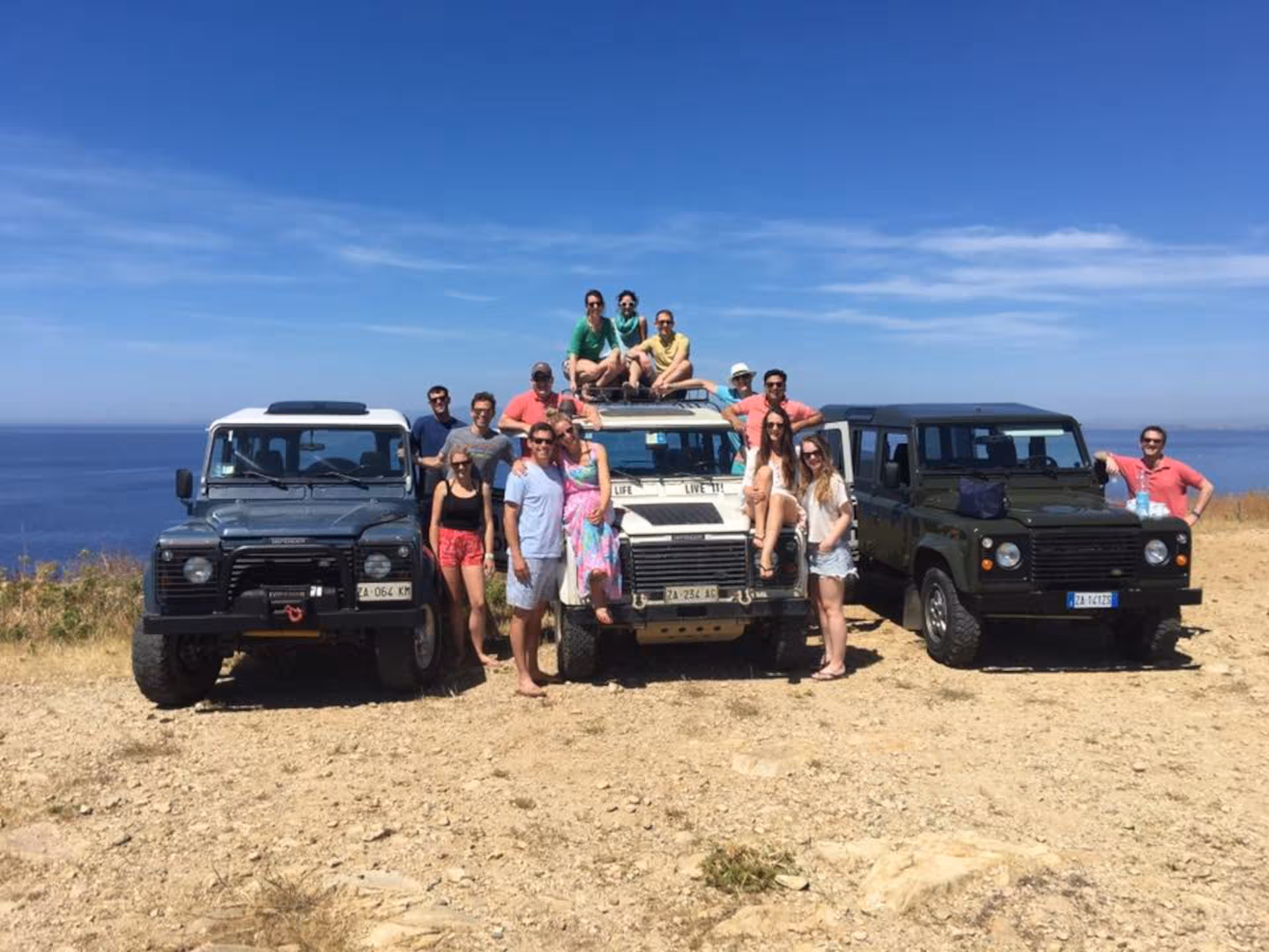 Group enjoying a scenic jeep tour to Chia with stunning sea views in Cagliari, Sardinia.