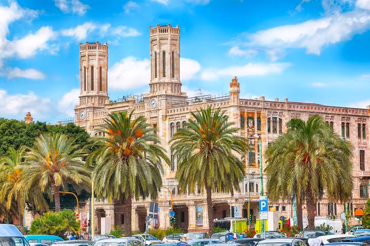 Cagliari city hall building with twin towers and palm trees in Sardinia, Italy