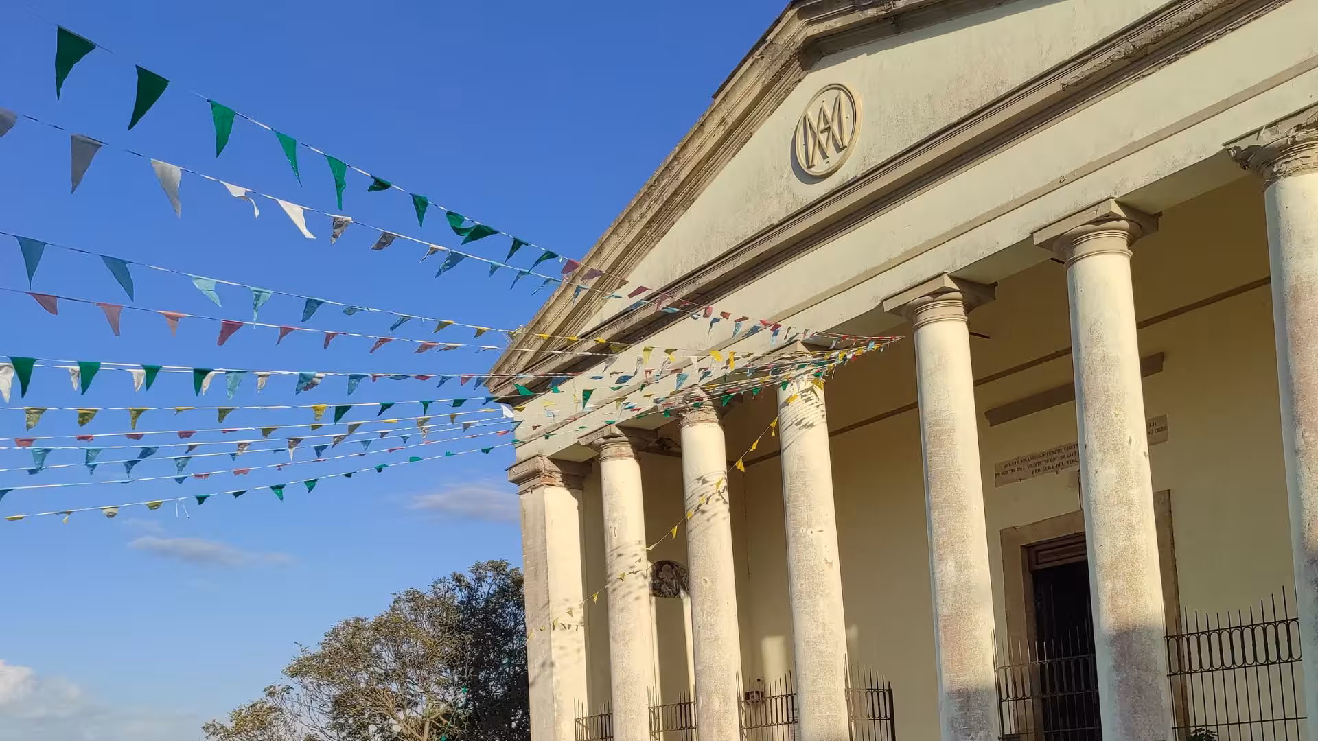 Historic building with colorful pennant flags in Cagliari, part of the picturesque ATV tour from Guasila.