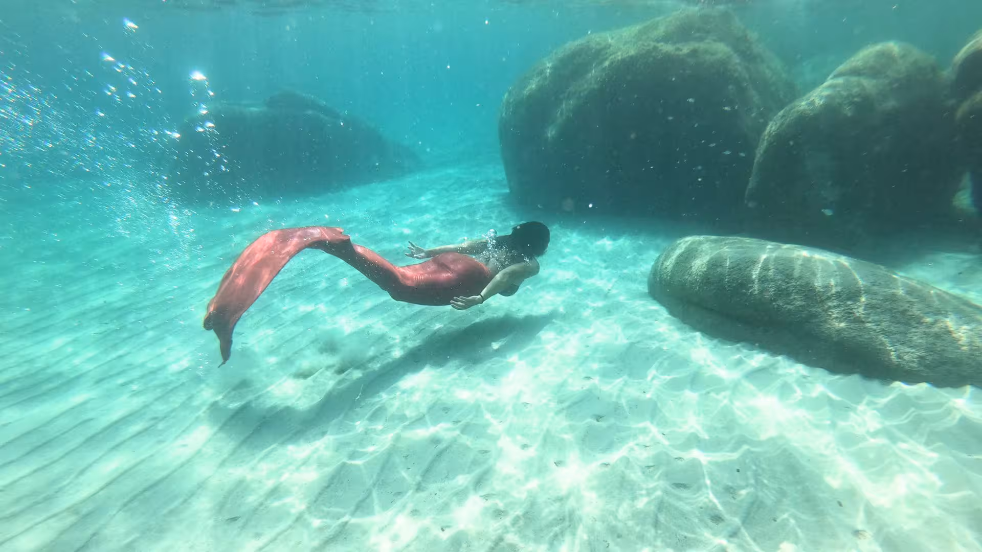 Experience the enchanting underwater world with a mermaid in the crystal-clear waters of the Gulf of Angels, Cagliari.