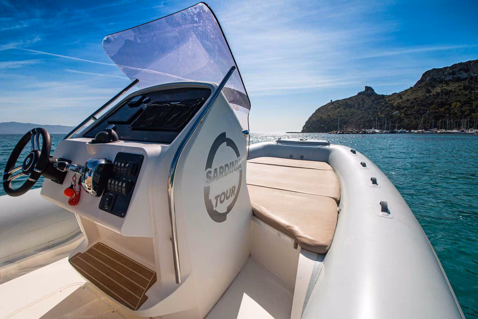 Sleek RIB boat with modern controls navigating the scenic waters of Cagliari on a sunny day tour.