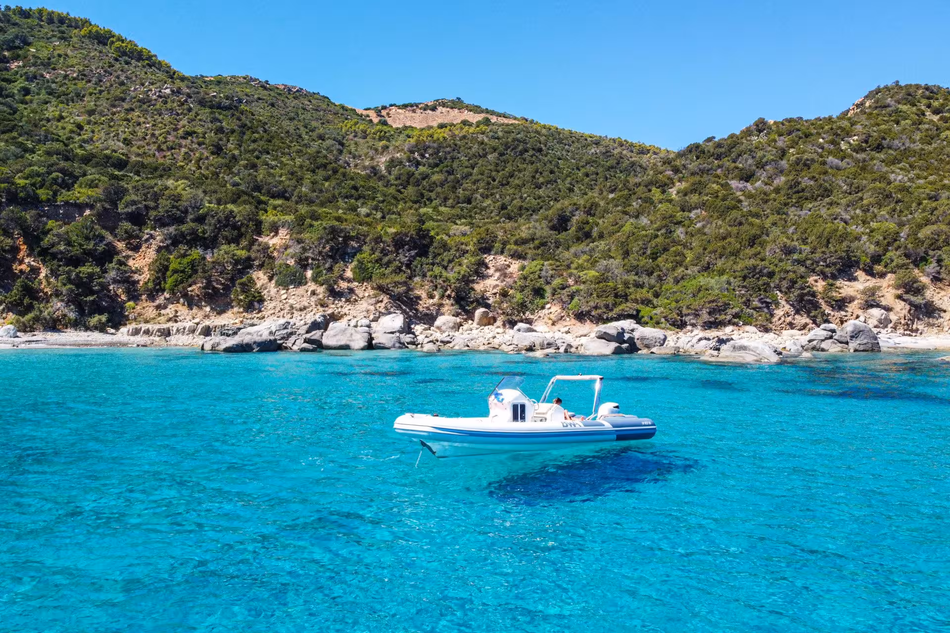 Explore Cagliari with a RIB tour showcasing stunning turquoise waters and lush coastal landscapes.