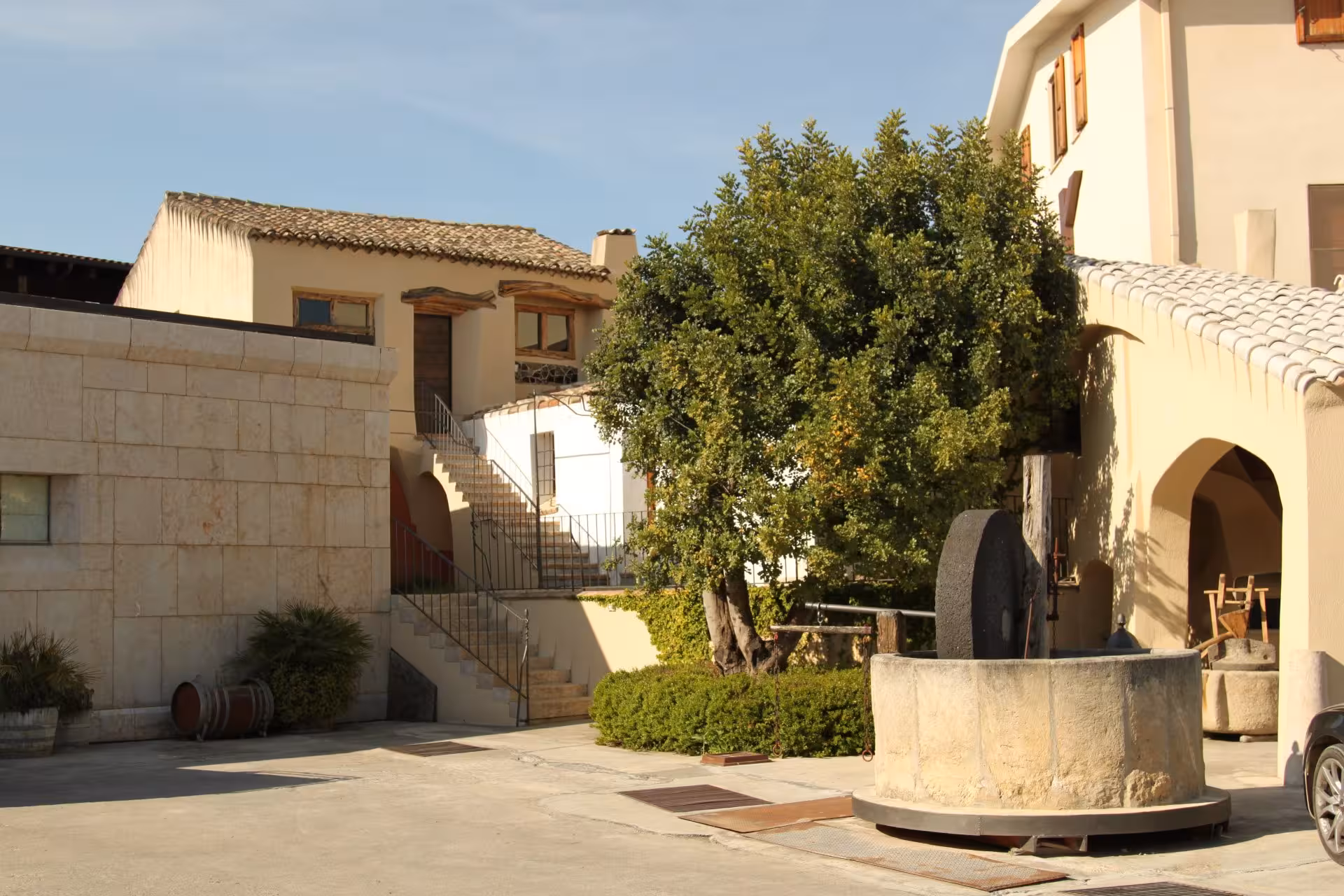 Charming exterior of a Cagliari winery with traditional architecture and lush greenery for tours.