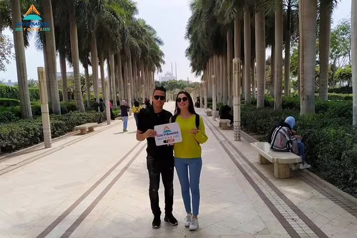 Travelers strolling a palm-lined walkway in Cairo, part of a 5-day Cairo short break city tour package