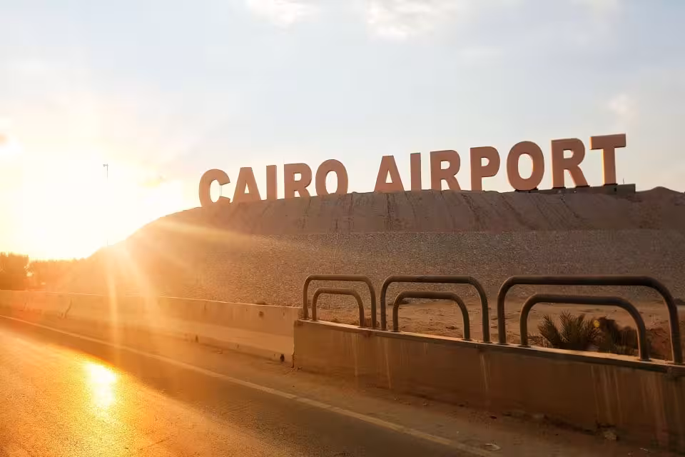 Cairo Airport entrance sign at sunrise, ideal for private arrival and departure transfer service in Cairo