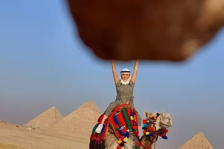 Cairo Airport private all-inclusive Giza Pyramids tour with camel ride photo and pyramids in background