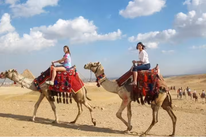 Private Cairo Airport layover tour with camel ride near Giza Pyramids, desert view and blue sky