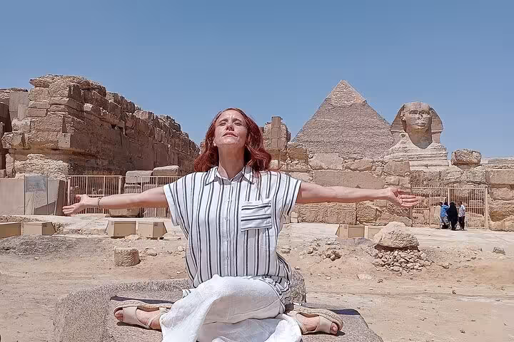 Traveler meditating near the Sphinx and Giza Pyramid on a Cairo airport layover tour stopover excursion