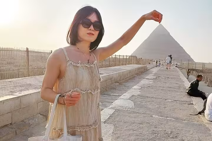 Traveler posing with Great Pyramid of Giza on Cairo airport layover tour to pyramids and Grand Egyptian Museum