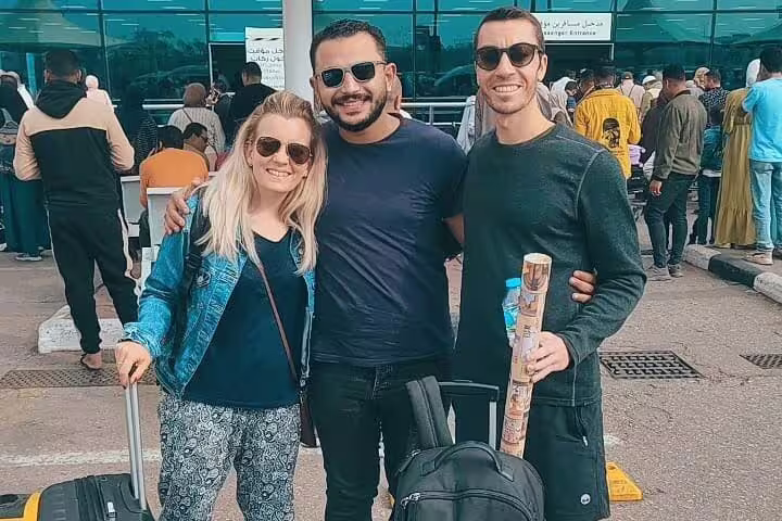 Travelers meeting driver outside Cairo Airport for reliable Cairo transfer service with luggage and assistance