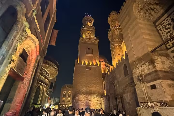 Night view of Al-Muizz Street minarets in Islamic Cairo, a hidden gems stop on Cairo culture and cuisine tour