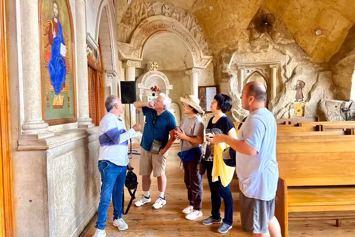 Tour group exploring an ancient Cairo church interior with guide, part of 3-day Cairo Giza Alexandria tour