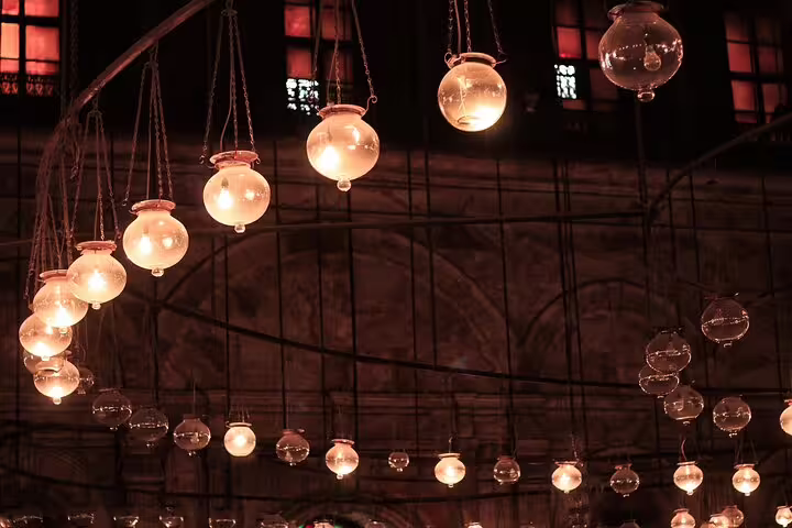 Hanging lanterns glowing inside Cairo bazaar, atmospheric stop on Old Cairo and Khan el-Khalili day tour