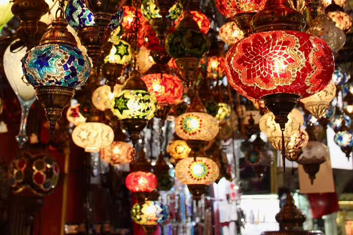 Colorful mosaic glass lanterns hanging in Cairo bazaar shop, a highlight of Citadel and museum tour
