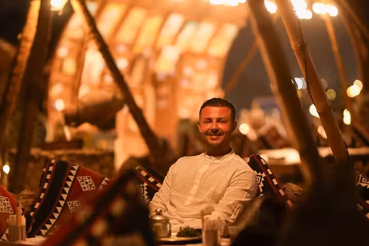 Guest relaxing in Bedouin lounge at VIP Arabian Night dinner and show in Giza desert camp with free photographer