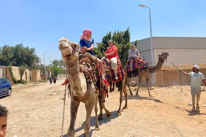 Tourists enjoy a Cairo camel ride with guide, part of desert quad bike, lunch and shopping tour package