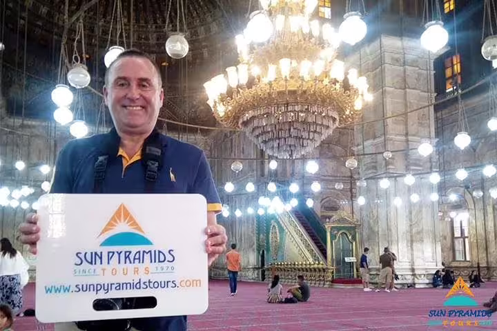 Visitor in Mohamed Ali Mosque, Cairo Citadel, under grand chandelier on 5-day Cairo vacation package tour