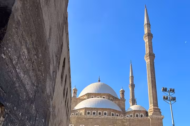 Mosque domes and minarets at Cairo Citadel under blue sky, highlight of private tour with Giza Pyramids and bazaar