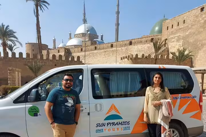 Tour van at Cairo Citadel with mosque domes and minarets behind, Citadel, Bazaar and Cairo Mosques day tour