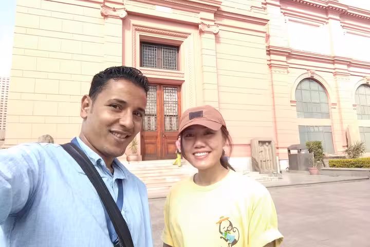 Tour guide and traveler selfie outside the Egyptian Museum in Cairo on a city tour of historic landmarks