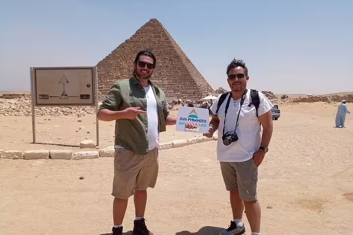 Travelers at the Great Pyramid of Giza on a Cairo day tour from Aswan by flight, Egypt sightseeing