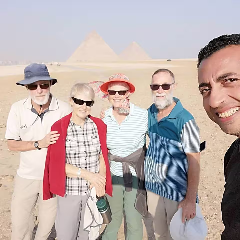 Tour group selfie at Giza Pyramids on private Cairo day tour by air from Sharm El Sheikh with guide