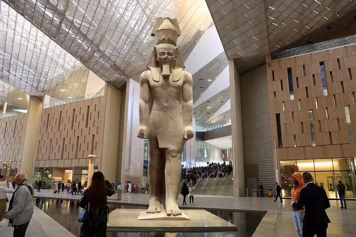 Colossal pharaoh statue at the Grand Egyptian Museum entrance hall, Cairo day tour by plane from Marsa Alam