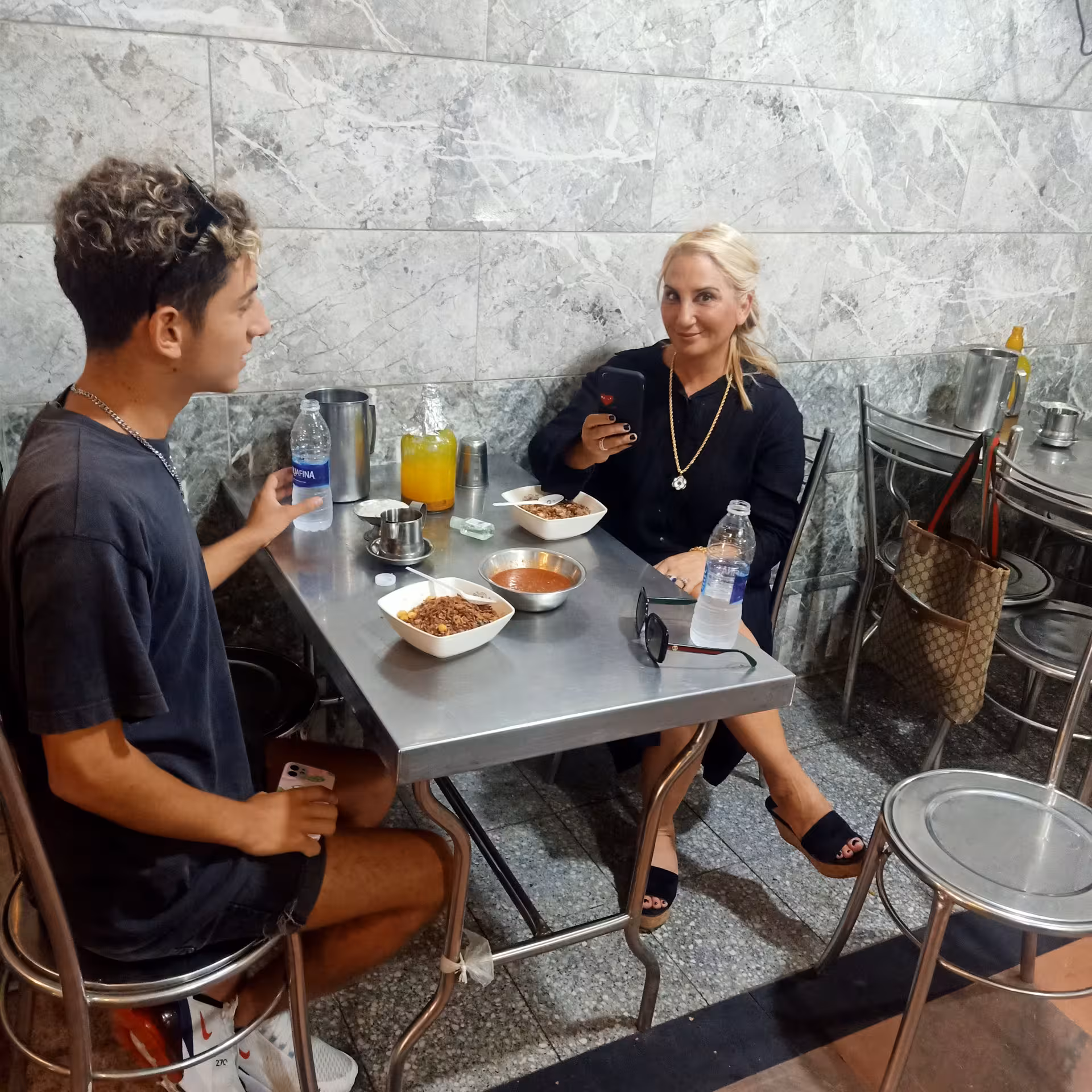 Guests enjoy koshari at a local eatery on a private Cairo food tour and funny walking experience in Egypt