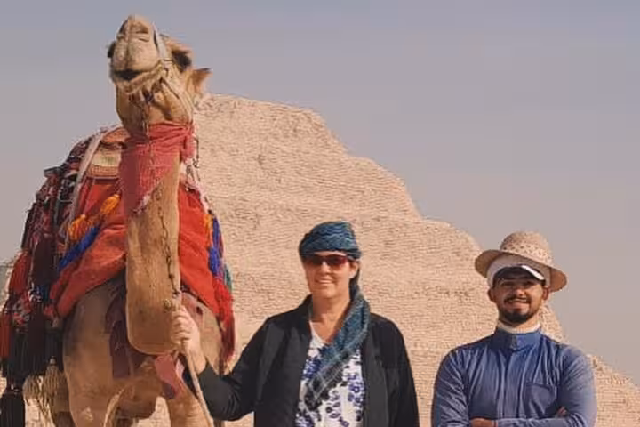 Tourists with camel and local guide near Giza Pyramid, Cairo experience on a private 3-day Cairo Alexandria tour
