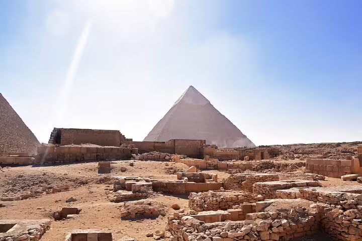 Ancient ruins near Giza Pyramid under blue sky on Cairo luxury tour linking Memphis, Sakkara and Dahshur sites