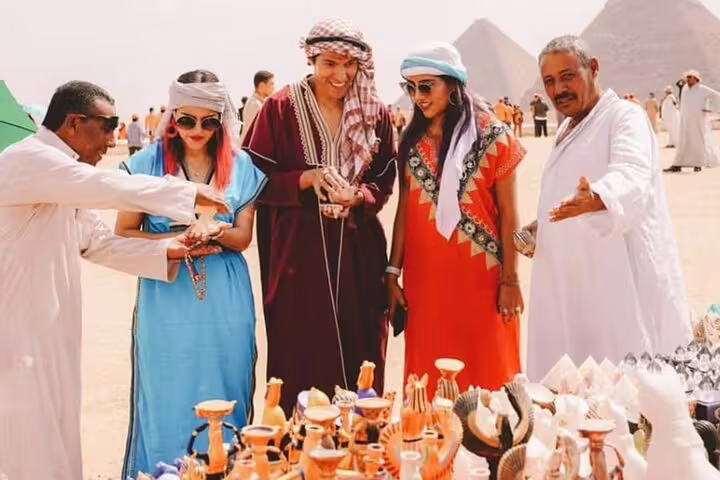 Travelers shop at Giza Pyramids bazaar for souvenirs on a Cairo 3-day highlights tour in Egypt
