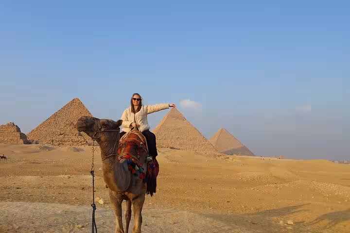 Camel ride at Giza Pyramids with panoramic desert view, highlight of Cairo 2-day tour itinerary