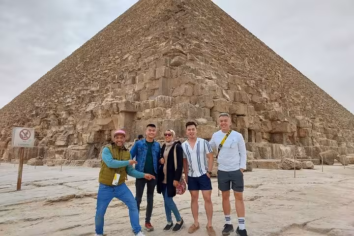 Private Cairo tour group photo at the Great Pyramid of Giza, guided visit to pyramids and Grand Egyptian Museum