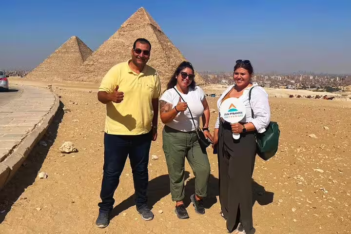 Travelers pose at Giza Pyramids viewpoint on Cairo luxury tour to Memphis, Saqqara and Dahshur