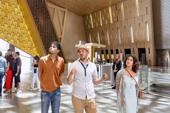 Guided Grand Egyptian Museum tour in Cairo with private guide and guests exploring the main hall