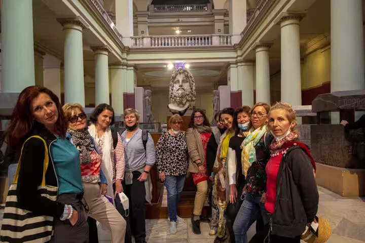 Tour group inside the Egyptian Museum Cairo, viewing ancient statues on a 3-day Cairo highlights tour